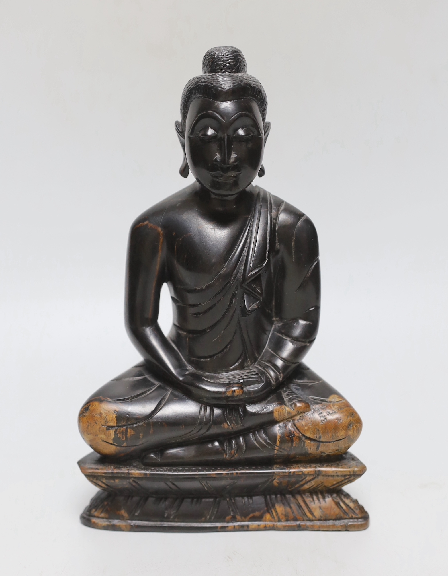 A Javanese carved wooden Buddha, 23cm tall